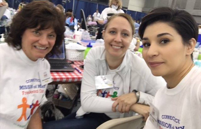 Three smiling team members at event