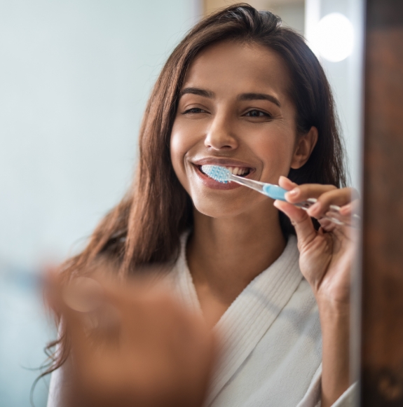 Dental team member smiling at dentistry patient