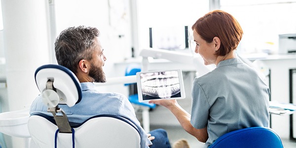 patient talking to dentist during consultation