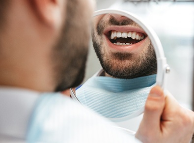 Patient looking at smile in reflection