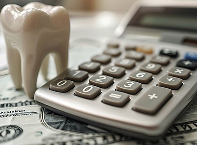Model tooth with calculator and money 