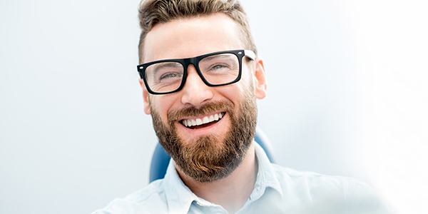 Man in dental chair smiling