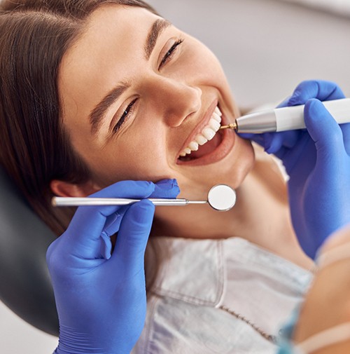Woman is smiling at the dentist