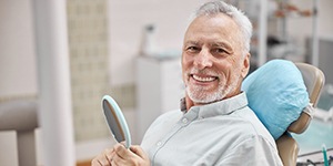 senior man smiling in the dental chair 