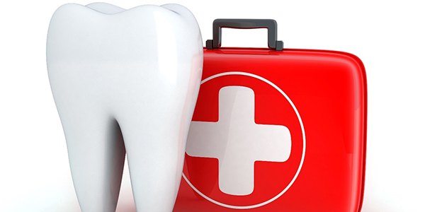 Tooth and red first aid kit from emergency dentist