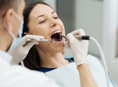 A dentist performing treatment on a patient.