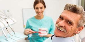 Man with mustache smiling in dental chair