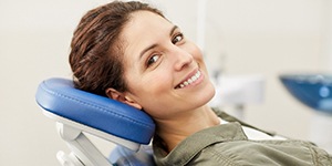 Woman smiling while sitting in the dental chair