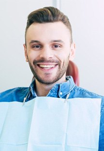 a patient smiling after receiving dental care