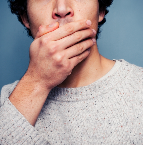 Man in pain holding cheek