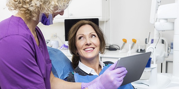 Dentist showing patient education video