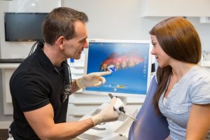 dentist designing same-day dental crowns for a patient