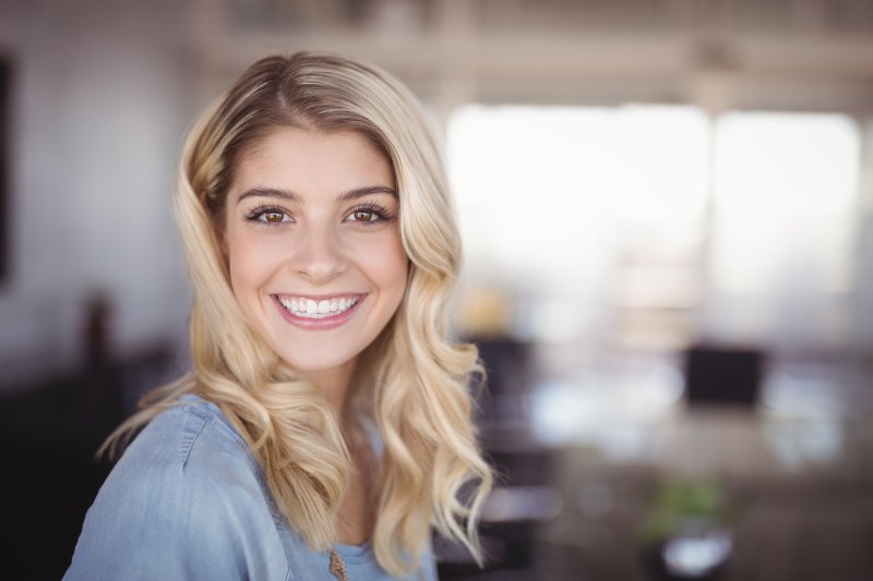 person who underwent cosmetic dental bonding smiling 