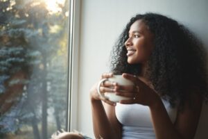Woman smiling with a cup coffee