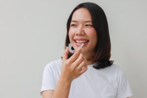 Woman putting in her Invisalign